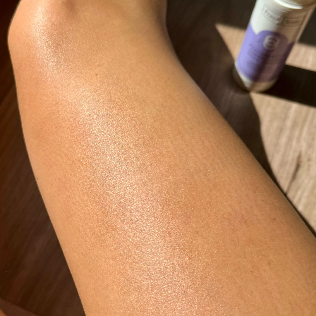 Before image for frank body Niacinamide Correcting Body Lotion: a bare forearm with the bottle on a table behind.
