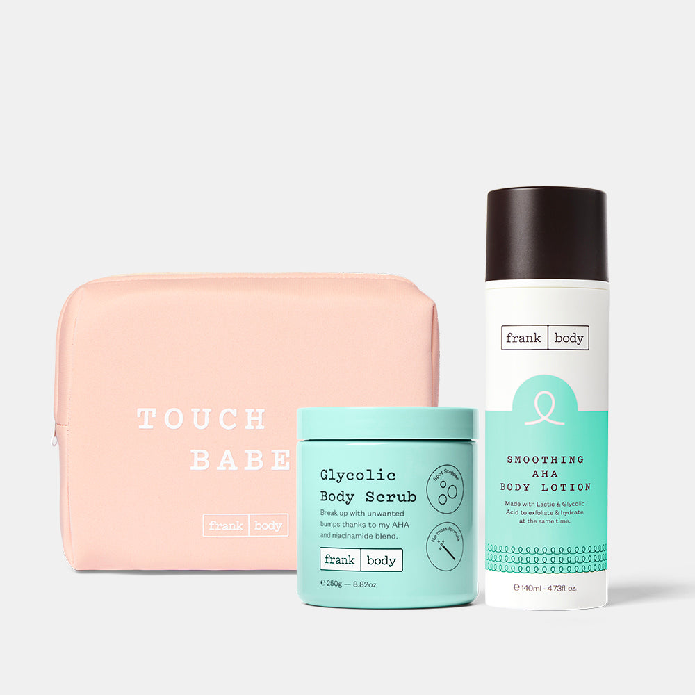 The frank body Acid Heroes Kit: Glycolic Body Scrub and Smoothing AHA Body Lotion with a pink Touch Me Babe pouch.