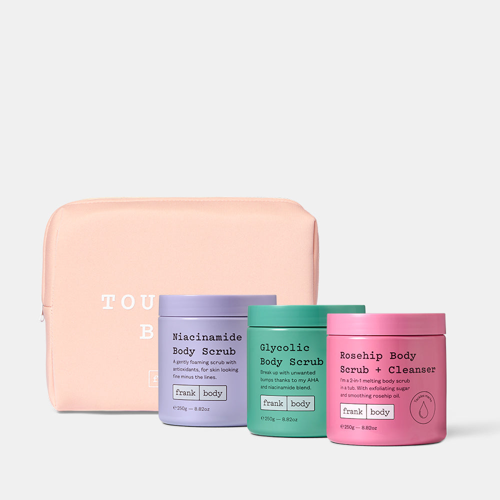 Set of four body scrubs and a pink pouch on a white background
