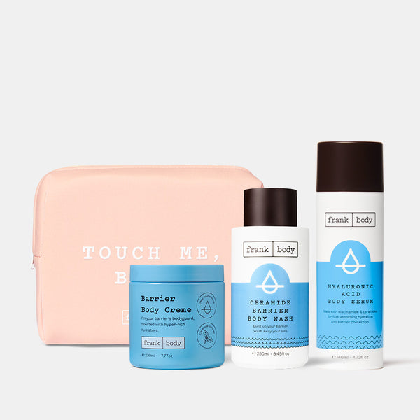 The frank body Sip & Slather Kit: Barrier Body Creme, Ceramide Barrier Body Wash and Hyaluronic Acid Body Serum with a pink Touch Me Babe pouch.