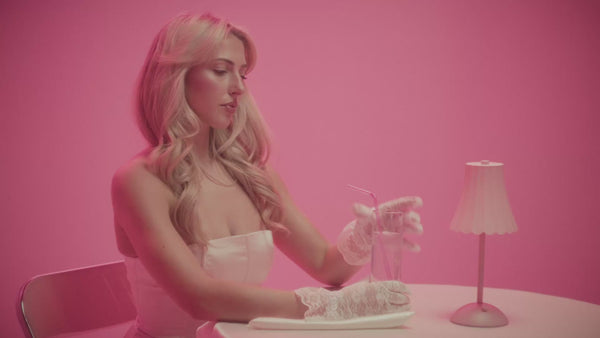 frank body Take a Tint Lip Tint Trio video: a silver dome is lifted to reveal three lip tints, and a model applies tint to her lips against a pink backdrop.